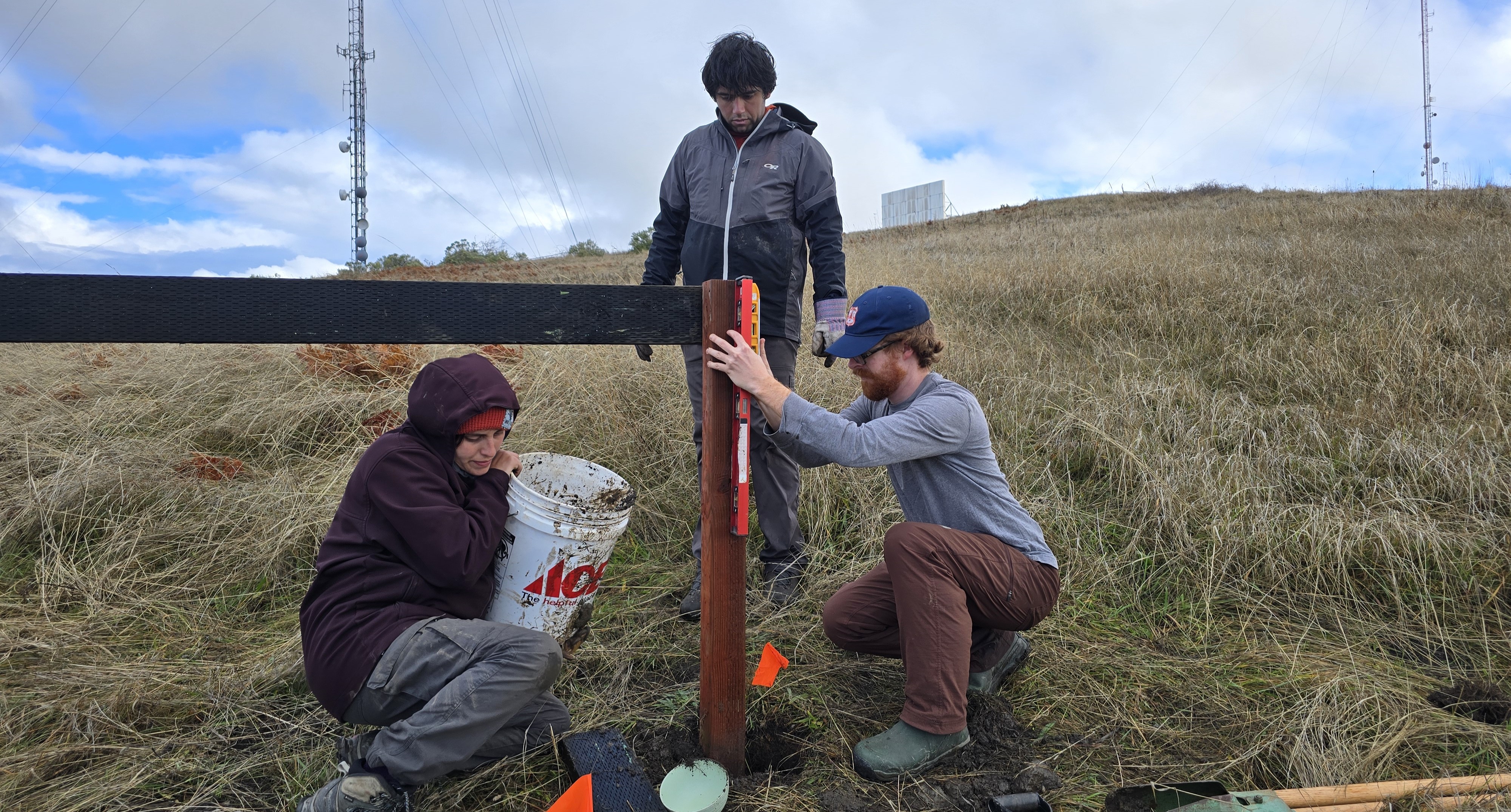 Graduate Students and Lab Manager setting up a drought structure